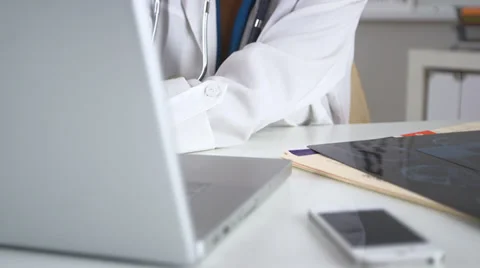Doctor working in office with computer Video stock 32424920