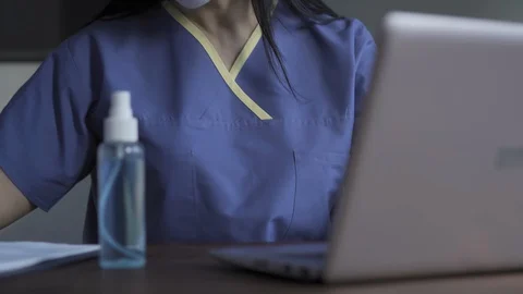 Doctor working on patients data using laptop Video stock 130048633