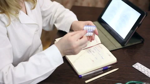 Doctor working with tablet computer and documents Stock Footage 59684627
