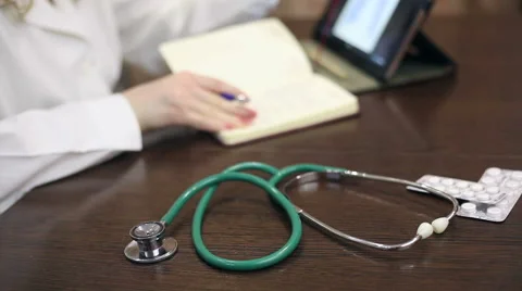 Doctor working with tablet computer and documents Stock Footage 59684725