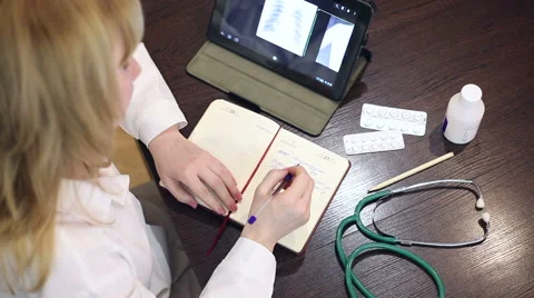 Doctor working with tablet computer and documents Video stock 59684811