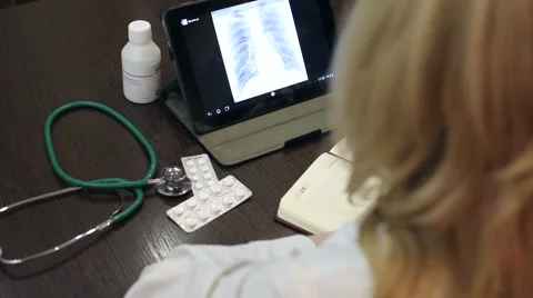 Doctor working with tablet computer and documents Video stock 59684833