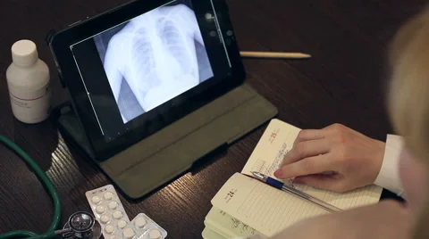 Doctor working with tablet computer and documents Video stock 59684863