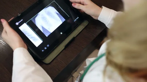 Doctor working with tablet computer and documents Video stock 59684871