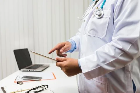 Doctor working with tablet computer at desk. Technology and medical concept. 스톡 사진