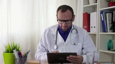 Doctor working on tablet computer in the office HD Stock Footage 25239644
