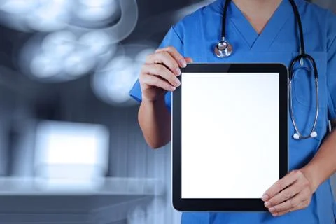 Doctor working with tablet computer with operating room Ilustración de archivo