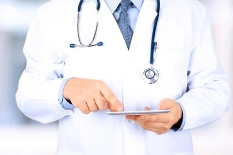 Doctor working with tablet computer. Stock Photos