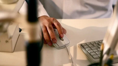 Doctor works with a computer mouse Stock Footage 99598912