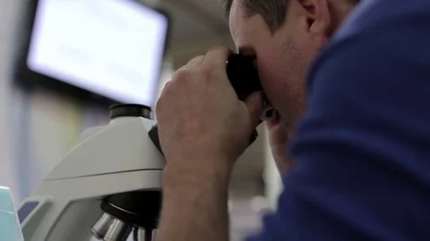 Doctor Works with a Microscope Stock-Footage 70358377
