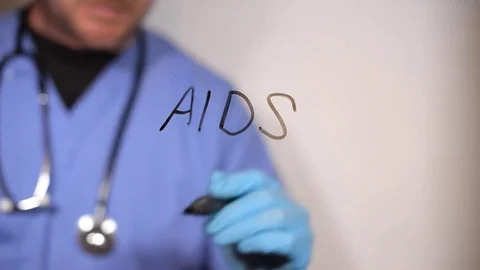 Doctor writes AIDS on a clear screen Stock Footage 79018037
