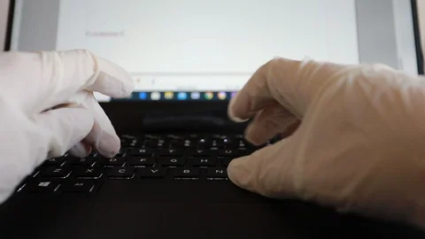 Doctor writes on the computer in his office using sterile gloves Video stock 127684524