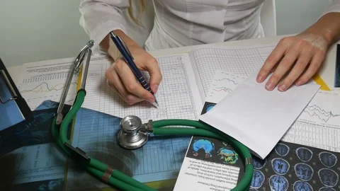 Doctor writes in the journal Stock Footage 86825412