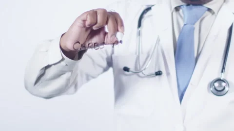 A doctor writes on the screen words Carbs are bad Stock Footage 248561973