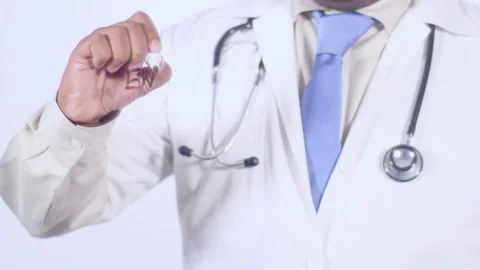 A doctor writes on the screen words Enzymes Stock Footage 248583486
