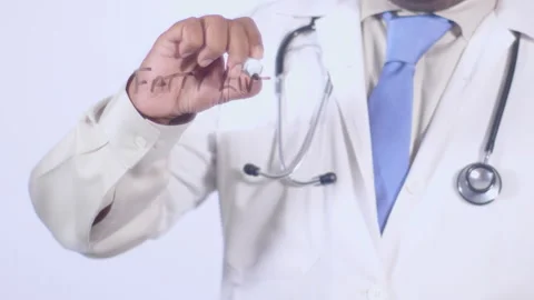 A doctor writes on the screen words Fatty liver disease Stock Footage 248576158