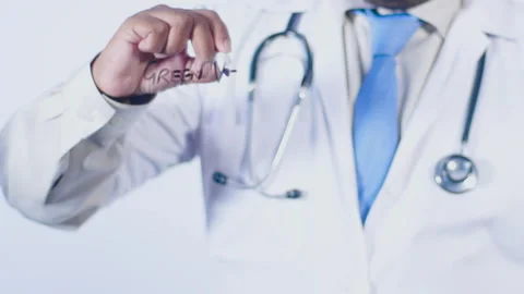 A doctor writes on the screen words Green vegetables Stock Footage 248554770