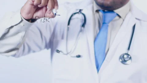 A doctor writes on the screen words Risk factors Video stock 248548331