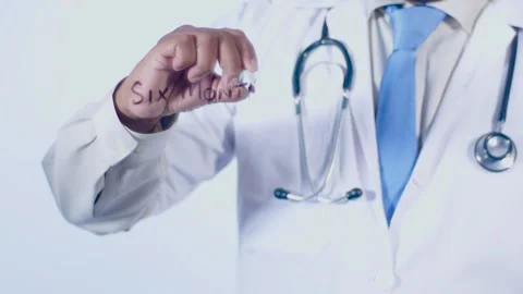 A doctor writes on the screen words Six months plan Stock Footage 248568571
