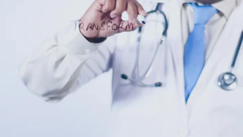 A doctor writes on the screen words Transform your body Stock Footage 248553177
