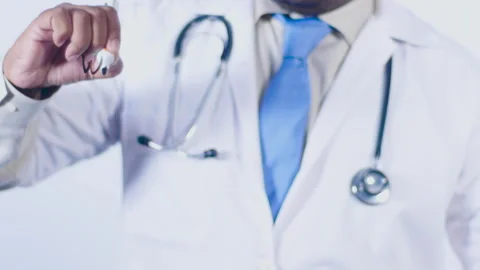 A doctor writes on the screen words Warts Stock Footage 248540016