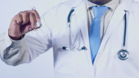 A Doctor Writes On transparent glass screen words Carbs kill Stock Footage 248564310
