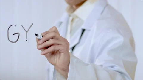 Doctor writes the word gynecology Stock Footage