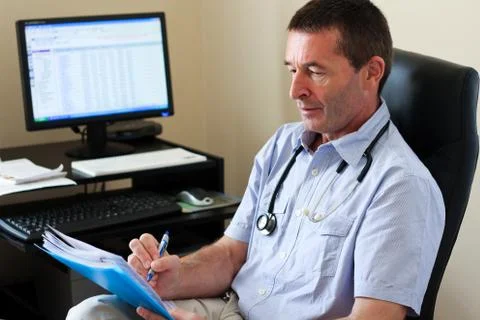 Doctor writing on a document Stock Photos