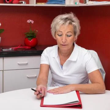 Doctor is writing a documentation Stock Photos