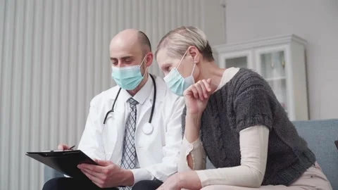 Doctor is writing down his recommendations to the clipboard. Stock Footage 157393639