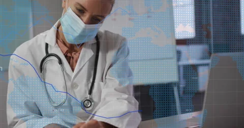 Doctor writing notes and tapping laptop, generating bar graphs, line chart and Stock Footage 311604863