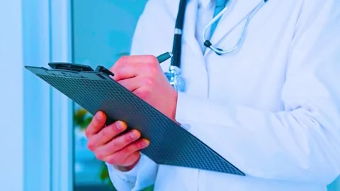 Doctor writing notes on clipboard patient medical record checkup examination Stock-Footage 341969945