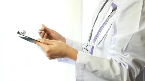 Doctor writing patient notes and medical report in the office of the clinic. Stock-Footage 336587932