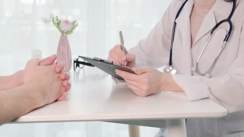 Doctor writing prescription and giving patient blister with pills closeup Stock Footage