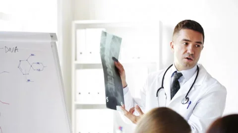 Doctor with x-ray and group of medics at hospital Stock Footage