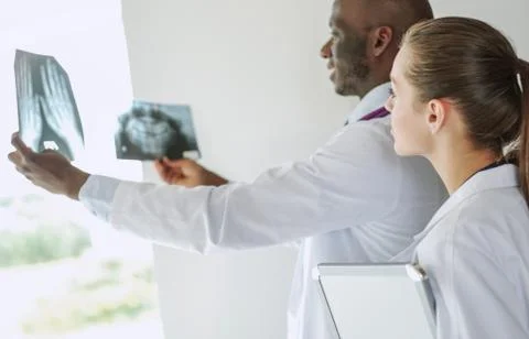 Doctors analyzing an x-ray in a meting. Doctors Stock Photos