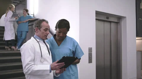 Doctors and nurse using digital tablet Stock Footage 24278256