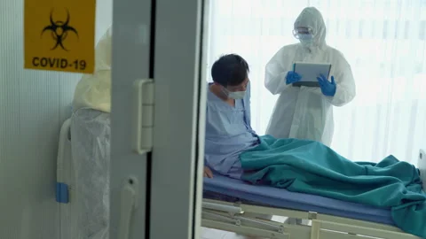 Doctors and nurses are helping to save the lives of patients suffering Stock Footage 136316107