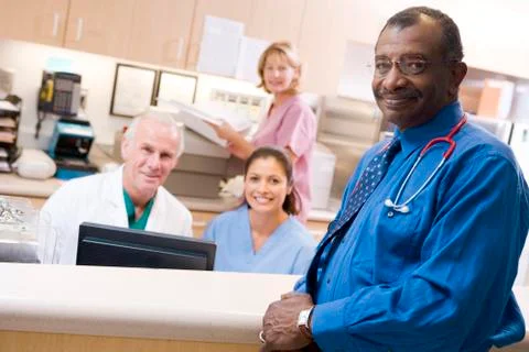 Doctors And Nurses At The Reception Area Of A Hospital Stock Photos
