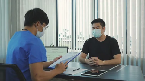 Doctors are explaining the treatment of a patient's illness while wearing a m Stock Footage 150844361