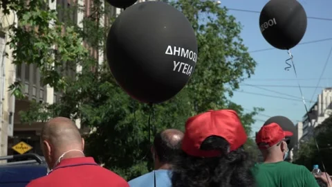 Doctors with black balloons protesting against the underfunding of the publi Stock Footage 142966947