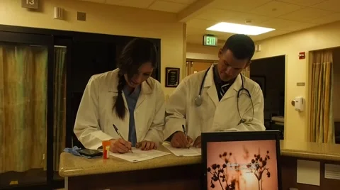 Doctors charting Stock Footage 40917621