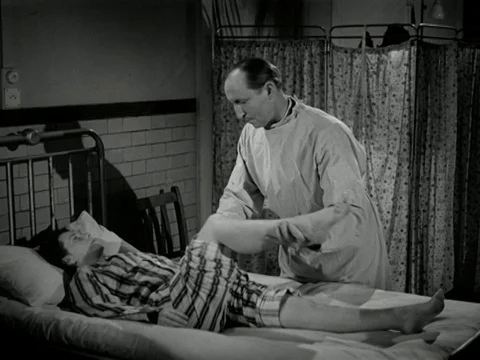 Doctors checking up on ill woman, talking about advancing Polio disease, 1947 Stock-Footage 134034003