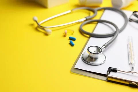 Doctor's desk top view. Set of different doctor accessories on a colored Stock Photos