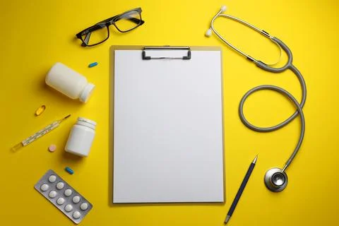 Doctor's desk top view. Set of different doctor accessories on a colored Stock Photos