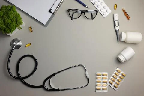 Doctor's desk top view. Set of different doctor accessories on a colored Stock Photos