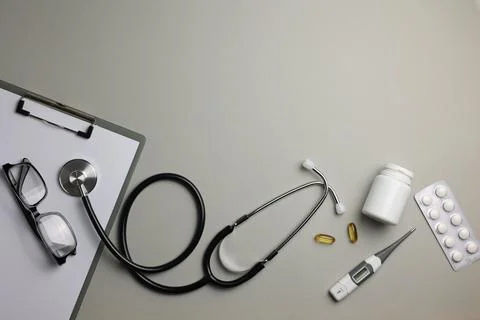 Doctor's desk top view. Set of different doctor accessories on a colored Stock Photos