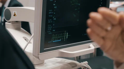 The doctors discuss the results of the study patient displayed on the screen Stock Footage 58813554