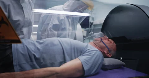Doctors discussing aged man in hyperbaric chamber Stock Footage 151636505