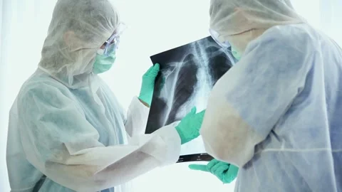 Doctors discussing and brainstorm about lung x-ray image from the patient Stock Footage 135446676